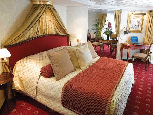Oceania-Owners-Suite-R-2 - Spanning nearly 1,000 square feet, the Owner's Suite aboard Oceania Insignia includes a queen bed with 1,000-thread-count linens, private teak veranda for watching the passing landscapes, a second bathroom, two flat-screen TVs, laptop, iPad, 24-hour butler service, complimetary in-suite bar setup, priority embarkation and more. 