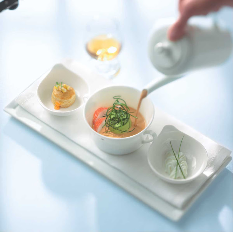 The lobster bisque being presented at Murano on Celebrity Cruises.