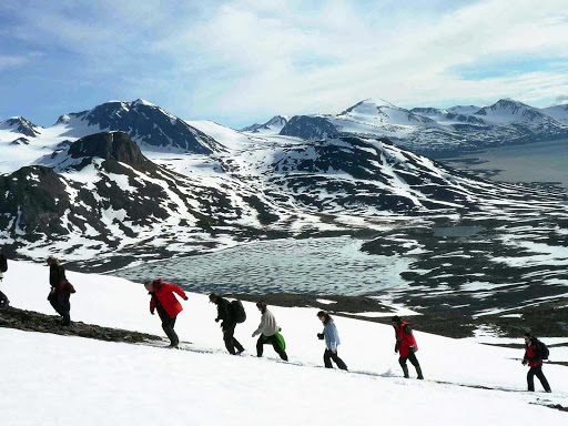 A group of hikers hiking the Spitsbergen Mountains on a G Adventures expedition in Spitsbergen, Norway.