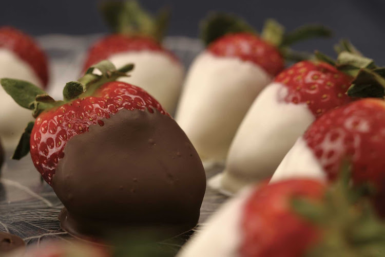Fresh strawberries dipped in rich chocolate presented during a cruise on Regent Seven Seas.