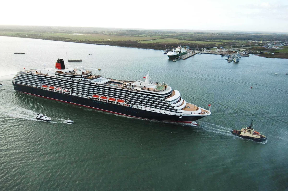 Cunard-Queen-Victoria-Southampton-arrival - A tugboat leads Queen Victoria to its home port of Southampton, England. 