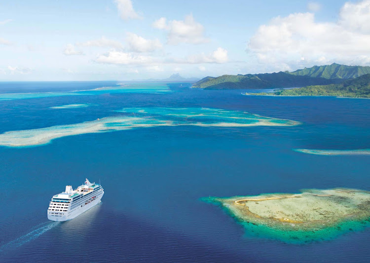  Ocean Princess — the smallest ship in the Princess fleet alongside her twin, Pacific Princess — sails through the emerald lagoon of Taha’a in French Polynesia.