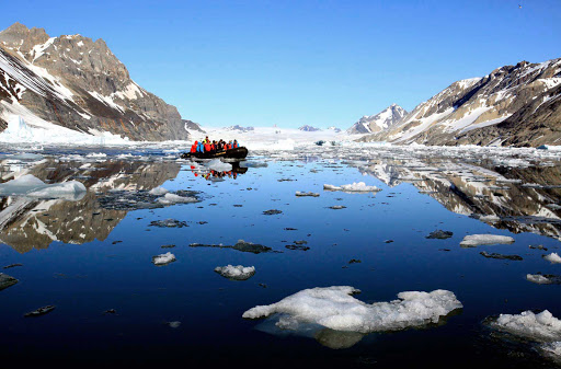 Svalbard-Fram-boat-ice - A small boat with take Hurtigruten Fram guests closer to the frigid landscape during an exploration of the Svalbard islands. 