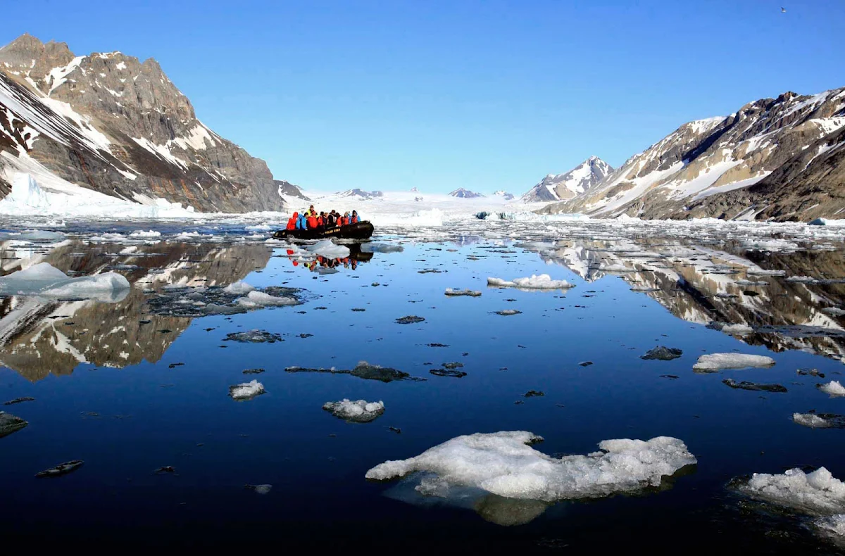 Svalbard-Fram-boat-ice - A small boat with take Hurtigruten Fram guests closer to the frigid landscape during an exploration of the Svalbard islands. 