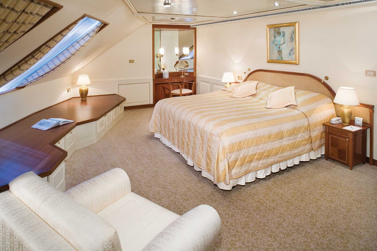 The Grand Suite aboard Silver Shadow has a spacious bedroom that features a queen size bed (or twin beds), sitting area and vanity table with hair dryer.