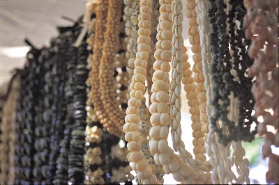 Near the entrance on the Waikiki Beach side, a sundry market is set up every Sunday at Kapiolani Park on Oahu. Lei made from shells and nuts are a popular item.