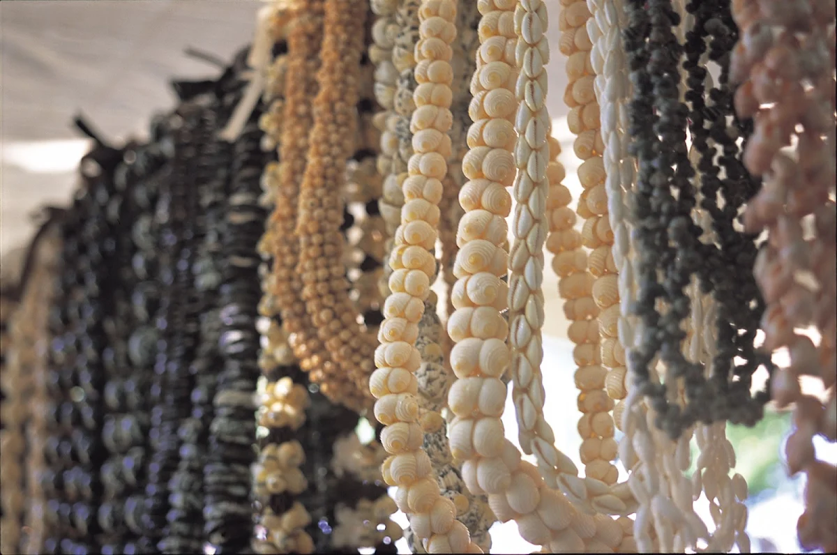 Hawaii-shell-nut-leis - Near the entrance on the Waikiki Beach side, a sundry market is set up every Sunday at Kapiolani Park on Oahu. Lei made from shells and nuts are a popular item.