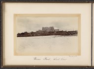 Phari Fort seen from the west with houses and pack animals surrounding it, Tibet