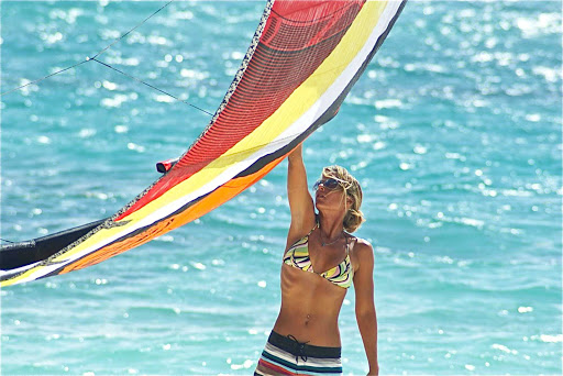 A woman preps for a kitesurfing outing in Mexico. Try it at Morph Kiteboarding in Tulum or El Cuyo, Yucatán. 