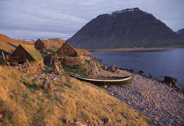 Turf houses along the rocky shores of Iceland.