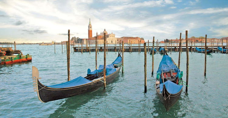 Gondolas in the waning afternoon hours in the Grand Canal of Venice, a city that combines history and romance. 