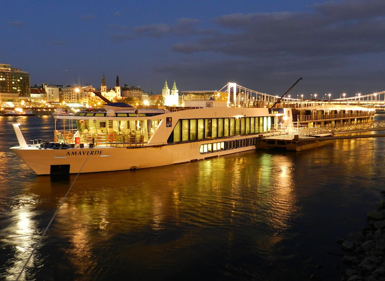 AmaVerde docked at night during a European river cruise. The this 161-passenger ship features twin balcony staterooms, a heated swimming pool, fitness center and a choice of dining venues.
