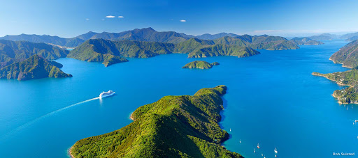 Cruising_in_Marlborough_Sound - On your cruise around New Zealand, Marlborough Sounds  promises to take your breath away. This vast network of drowned valleys is full of perfect bays, beaches and islands that can be reached only by water. There’s also a good chance your ship will be escorted by a pod of local dolphins.