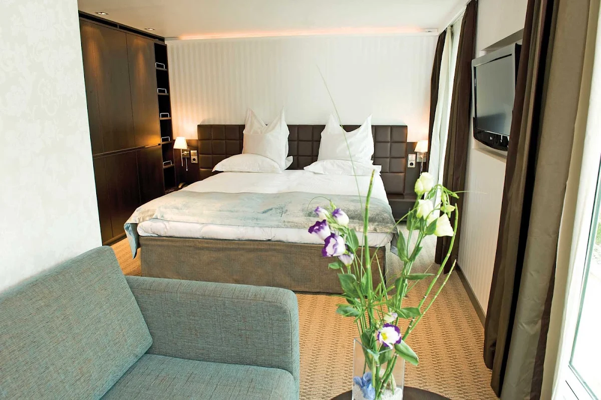 Scenic-Cruises-Contemporary-Accommodation - Guests on Scenic Cruises will find accommodations with contemporary interiors, a flat screen TV, couch, large bed and space to relax and enjoy the passing views.  