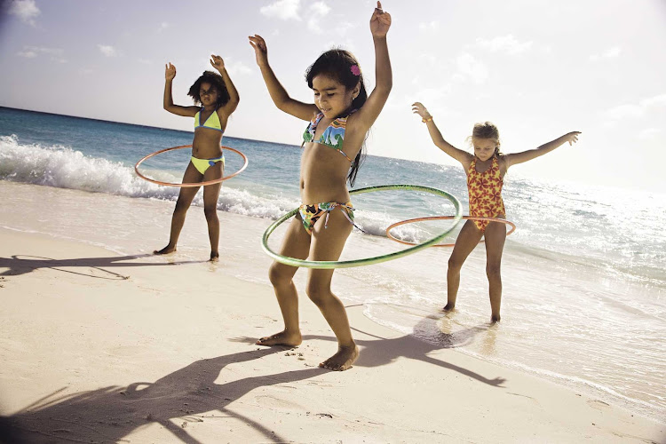 Kids get in some hula hoop action on the beach in Aruba.