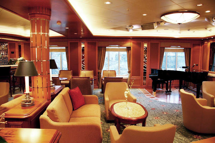 Order a cocktail and mingle with guests at the Chart Room aboard Queen Victoria.