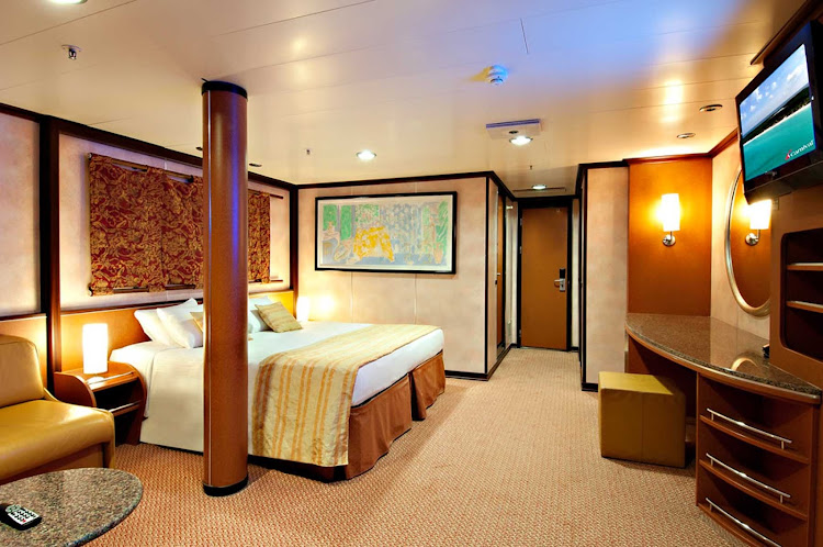 Cruise in style in Carnival Inspiration's Grand Suite, spacious personal quarters with a private balcony, king-size bed and other amenities.