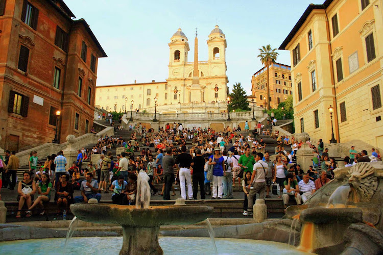Sunset at the Spanish Steps (Scalinata della Trinità dei Monti) in Rome offers a perfect venue for people-watching. It's been a magnet for visitors since the 1700s.  