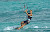 A kiteboarder glides across the surf in Mexico. 