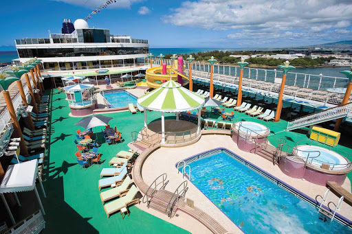 Norwegian-Jade-Pool-Deck - Take a dip in a sparkling pool, lounge in a comfy chairs or have a nice soak in the hot tub on deck 12 of Norwegian Jade.