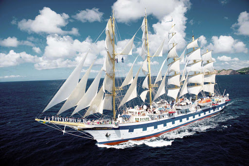 Crew and guests gather on the bow of Royal Clipper, the world's only five-masted full-rigged sailing ship. 