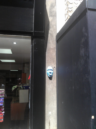 Blue Face in Wall