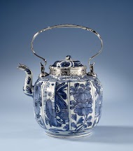 Teapot with panel decoration with flowering plants, figures and silver mounts