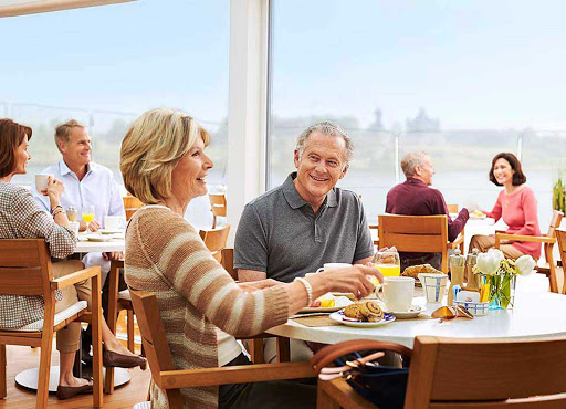 Indulge in good company and scenic views during meals in the Aquavit Terrace restaurant aboard your Viking River cruise. 