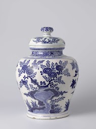 Two beaker vases and a lidded jar, part of a garniture