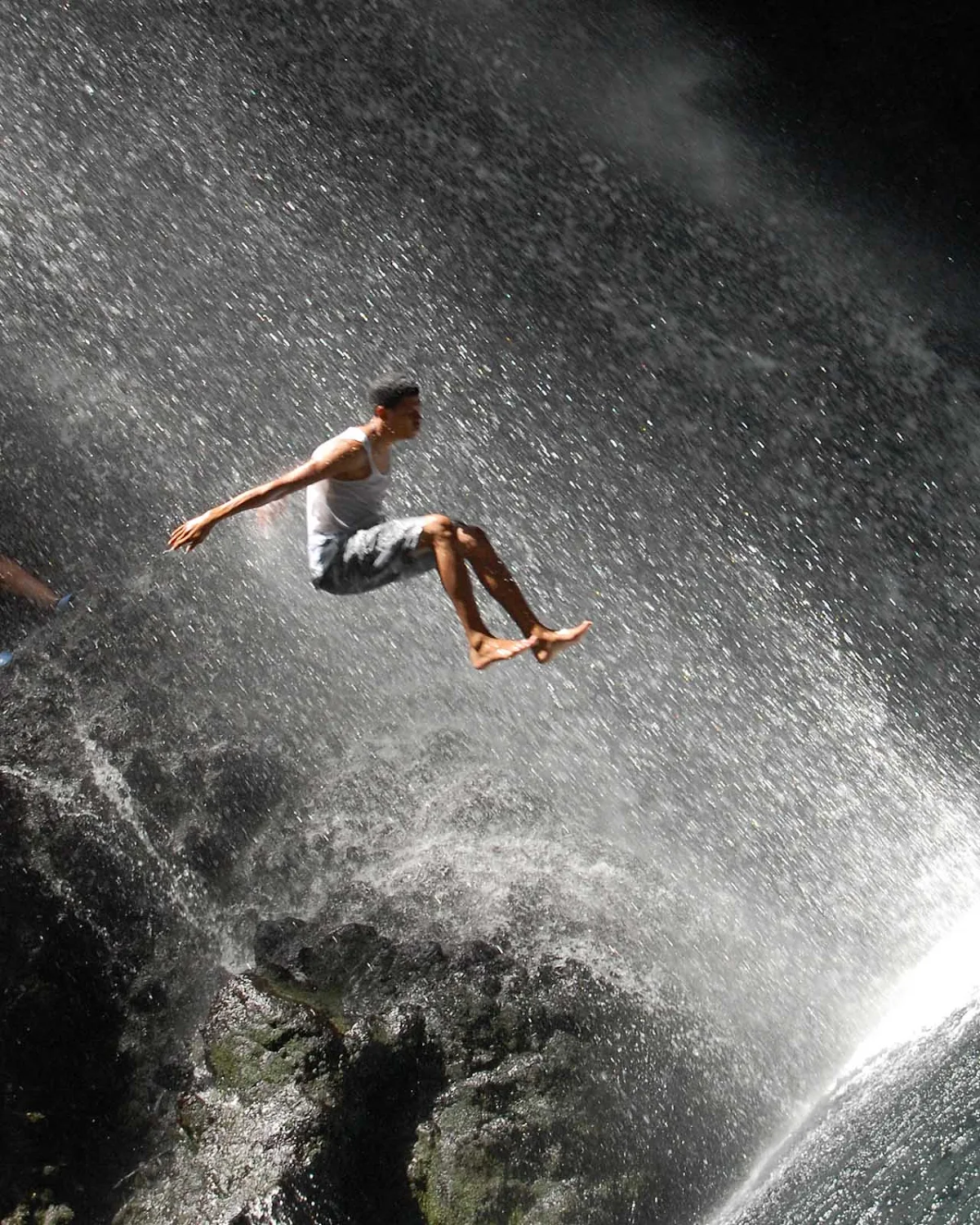 jumping-Belaine-Falls-St-Vincent-Grenadines - Taking a running jump at the Falls of Baleine on St. Vincent.