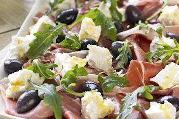 Serrano ham, olive, feta & rocket platter with homemade crostini