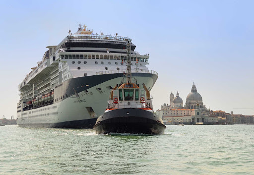 Celebrity Summit is towed by the tugboat Vanna C as it departs Venice. In the background is the basilica Santa Maria della Salute.