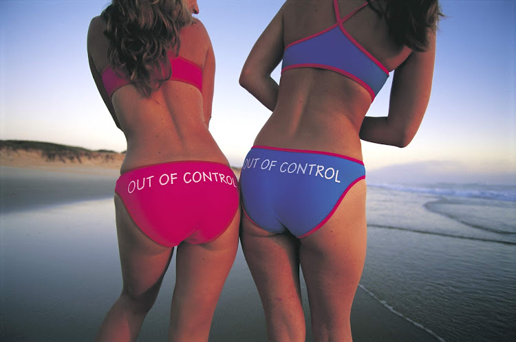 Two young women on the beach at Hat Head, near South West Rocks, Kempsey, North Coast, New South Wales, Australia.