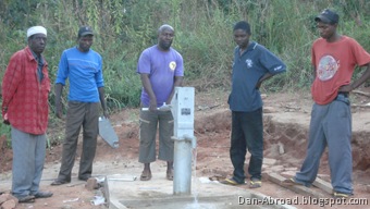 The well assembly team poeses for one final photo as Foster pumps the first bit of clean, safe water from this well.