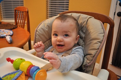 hudster playing in his high chair