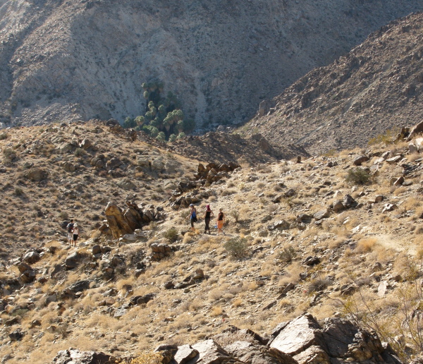 the crew making their way to the spot of water welling from the earth