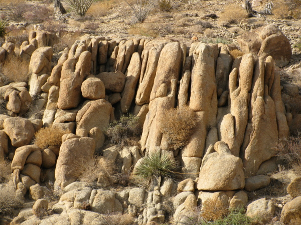 a crowd of people carved into the rocks by the wind
