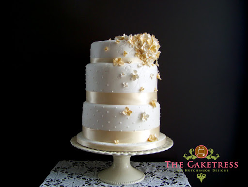 These small sugar flowers excel in striking decor of this wedding cake
