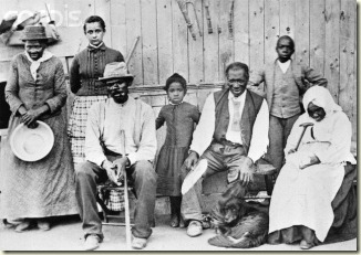 Harriet Tubman with a few people she helped during the Civil War. She is to the far left with a pan in her hands.