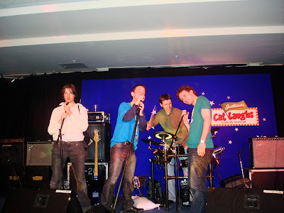 4 people on a stage singing at microphones and posing like ponces - three of them are me, Anthony McG and Darren Byrne
