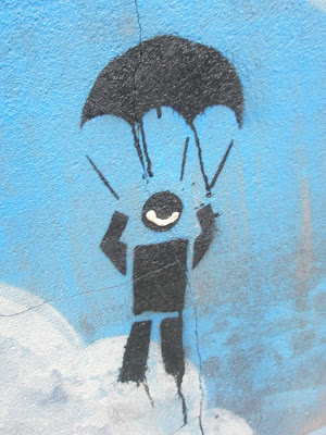 graffiti showing stick man on a parachute and someone has added a big smile