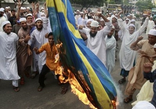 Pavel Rahman Bangladeshi Muslim protesters shout slogans as they burn a Swedish flag during a protest against social networking website facebook for holding a competition on caricatures of Prophet Mohammed, in Dhaka, Bangladesh, Friday, May 28, 2010