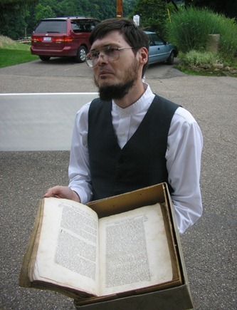Seth Hinshaw displaying an old Quaker text