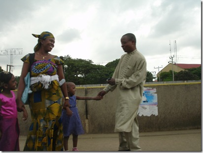 Happy family in traditional outfit in lagos, going home after Sunday mass