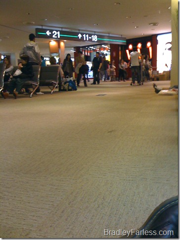 Sitting on the floor near my connecting flight's gate, charging my phone at a wall outlet. Sitting on the floor near my connecting flight's gate, charging my phone at a wall outlet.