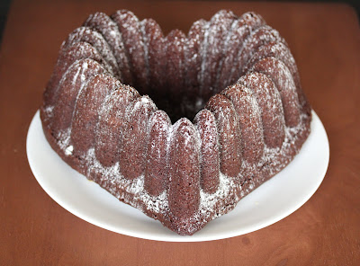 photo of a chocolate pound cake dusted with powdered sugar
