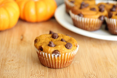 photo of a pumpkin muffin with more on a plate in the background