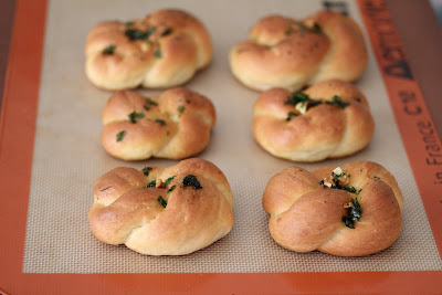 photo of garlic knots on a baking sheet