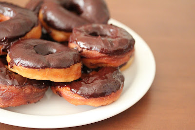photo of a plate of chocolate glazed donuts