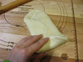 process photo showing how to start rolling the dough like a swiss roll